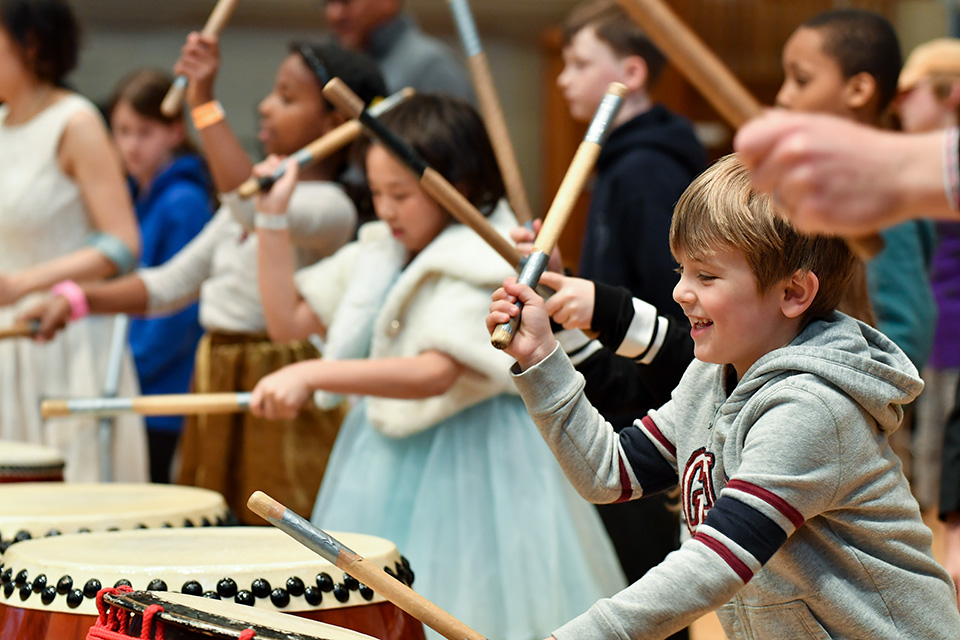 Children playing taiko drums in the Amaryllis Fleming Concert Hall